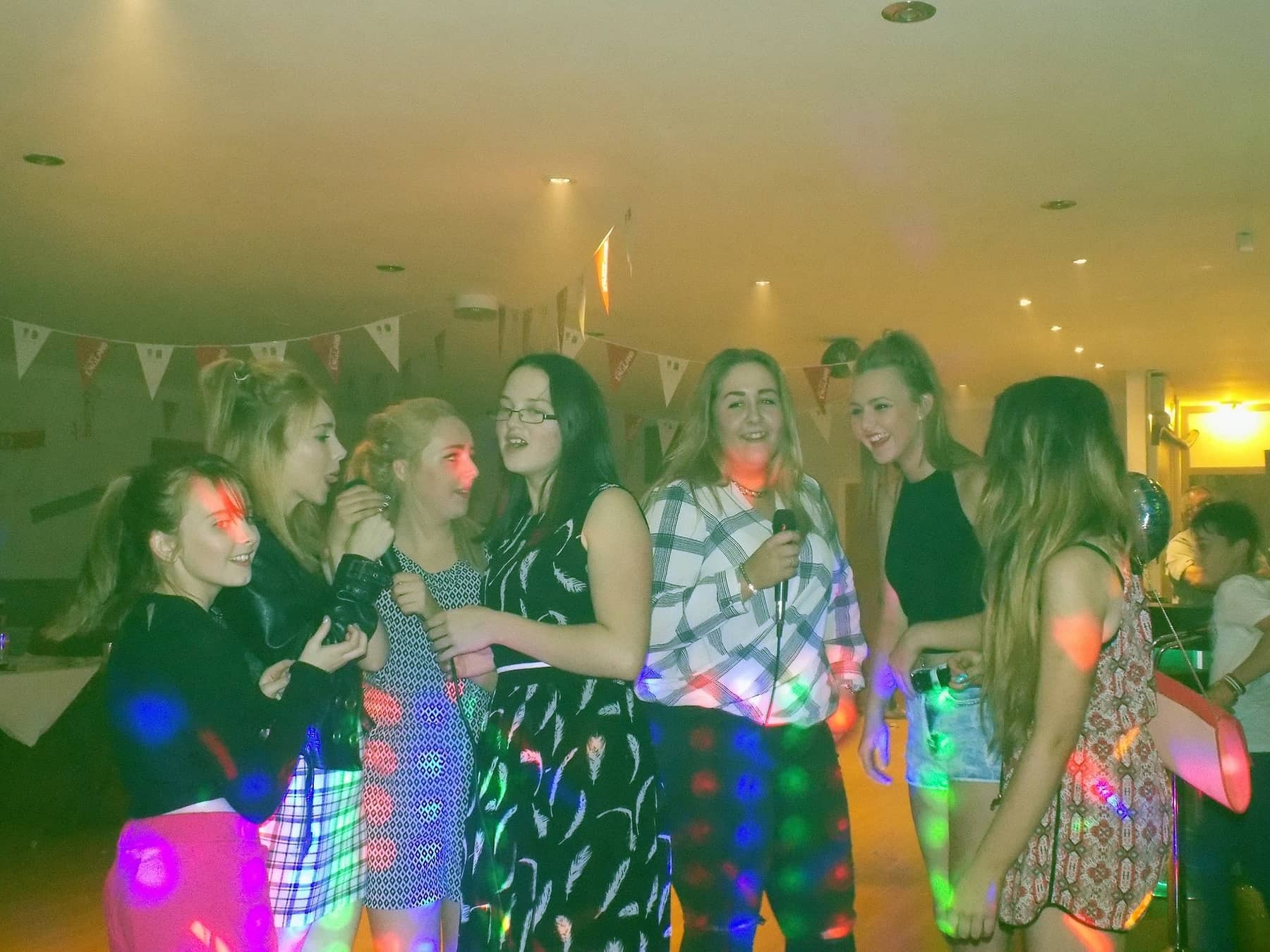 Guests dancing and laughing at a party