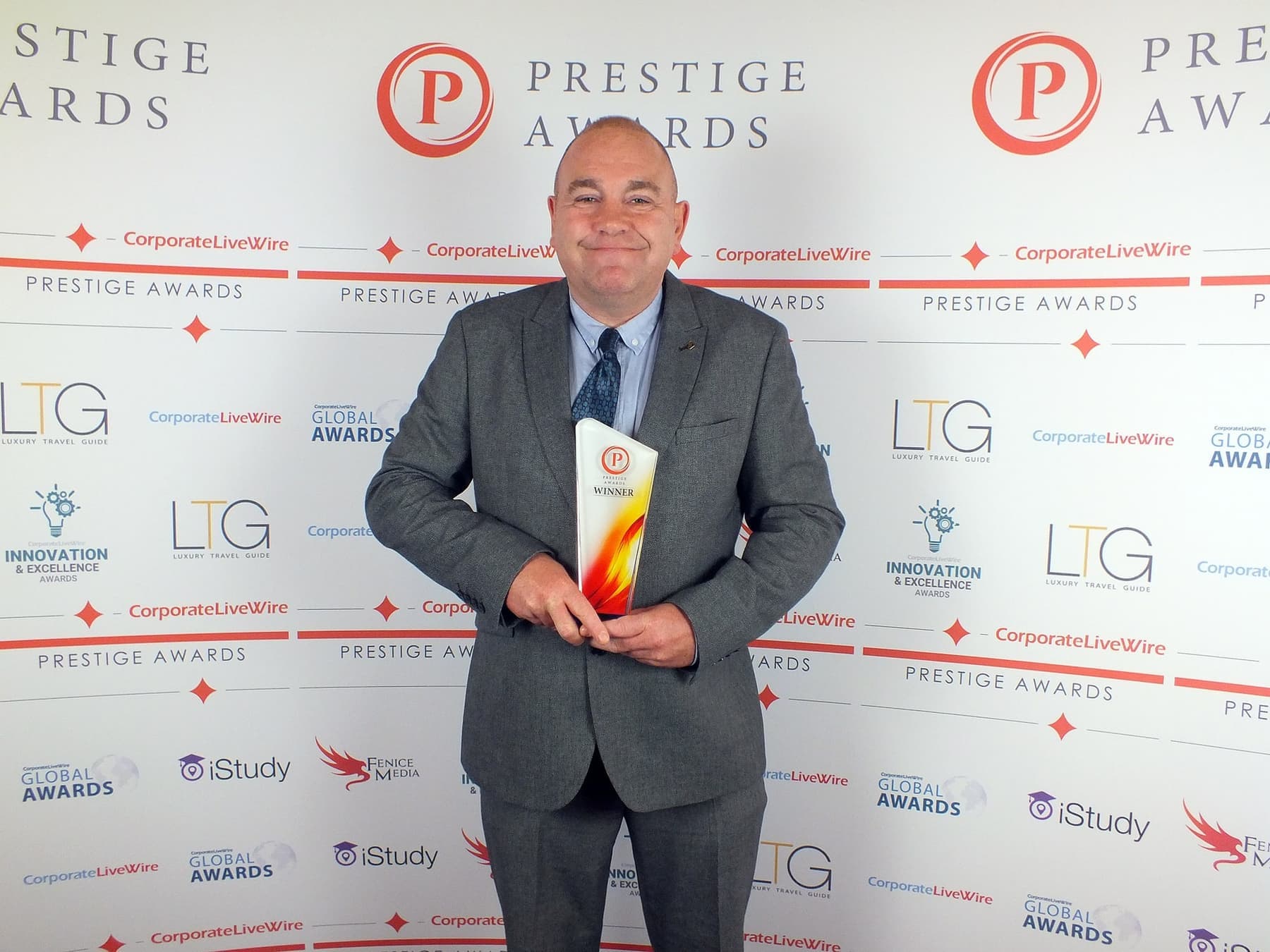 Simon Aston holding his Yorkshire Prestige Awards trophy at the awards night